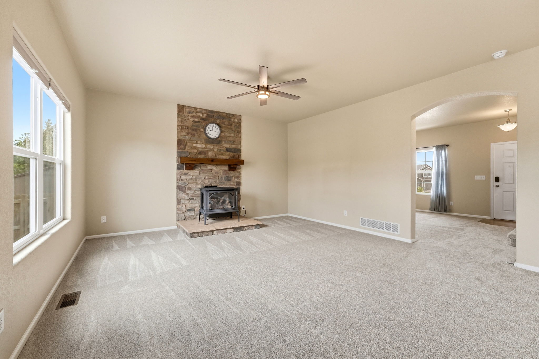 Stone Surround Gas Fireplace with Wooden Mantel