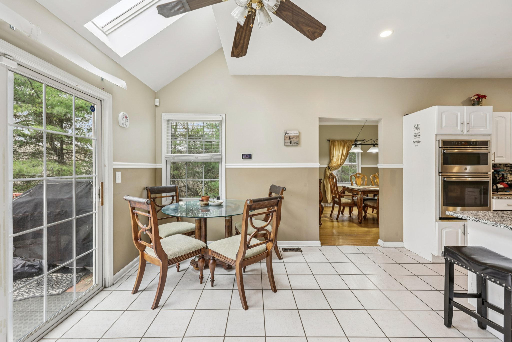 Separate eating area in kitchen high ceilings with skylights