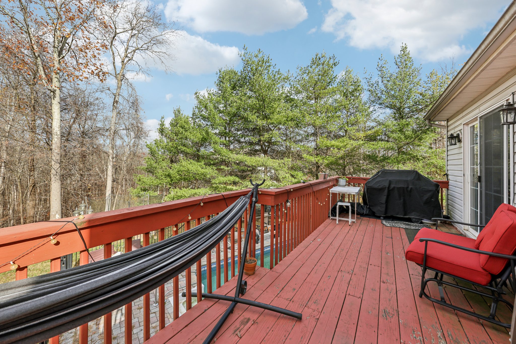 Deck overlooking yard and pool