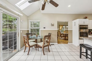 Separate eating area in kitchen high ceilings with skylights