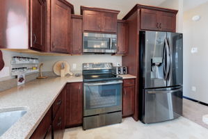 Rich custom cabinetry black stainless steel appliances