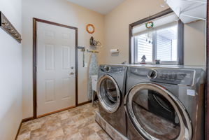 Main level laundry room, laundry tub, pocket door