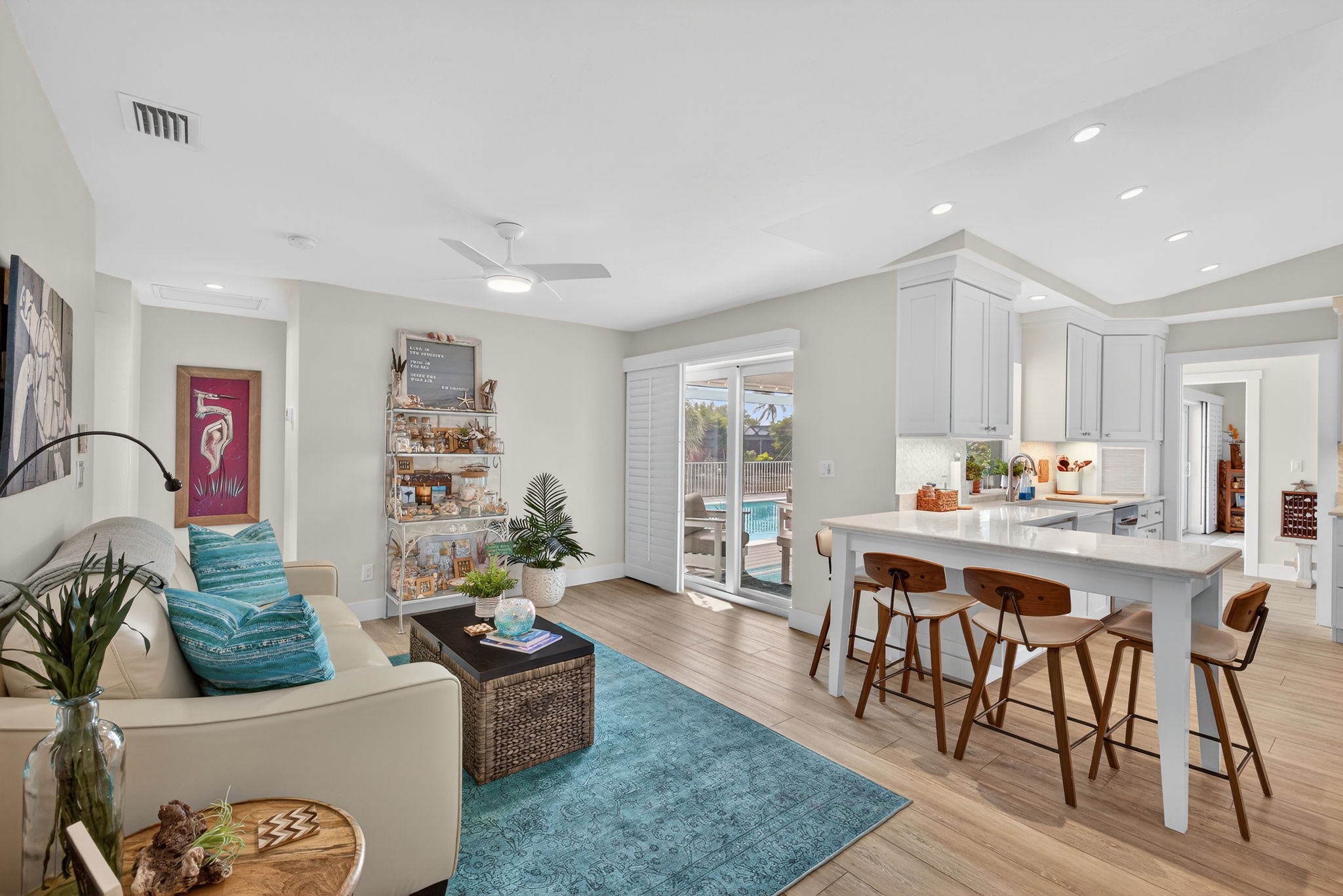 please duplicate this photo and use virtual staging on the copy to create a dining room table near the sliders.