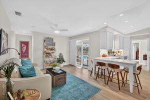 please duplicate this photo and use virtual staging on the copy to create a dining room table near the sliders.