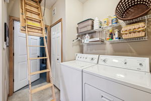 stairs fold down to access the storage space built into the attic by the builder