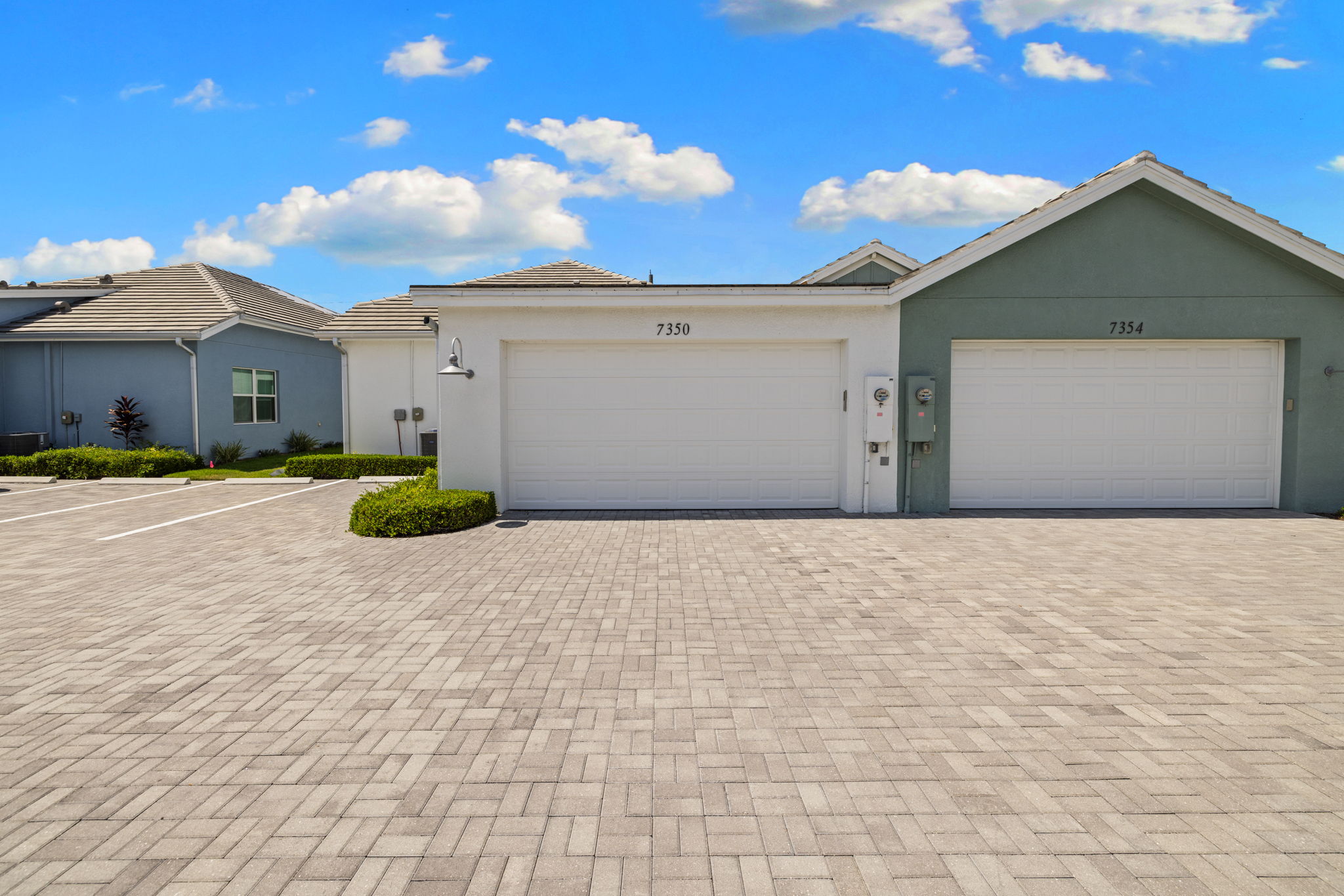 White garage has keypad and door openers