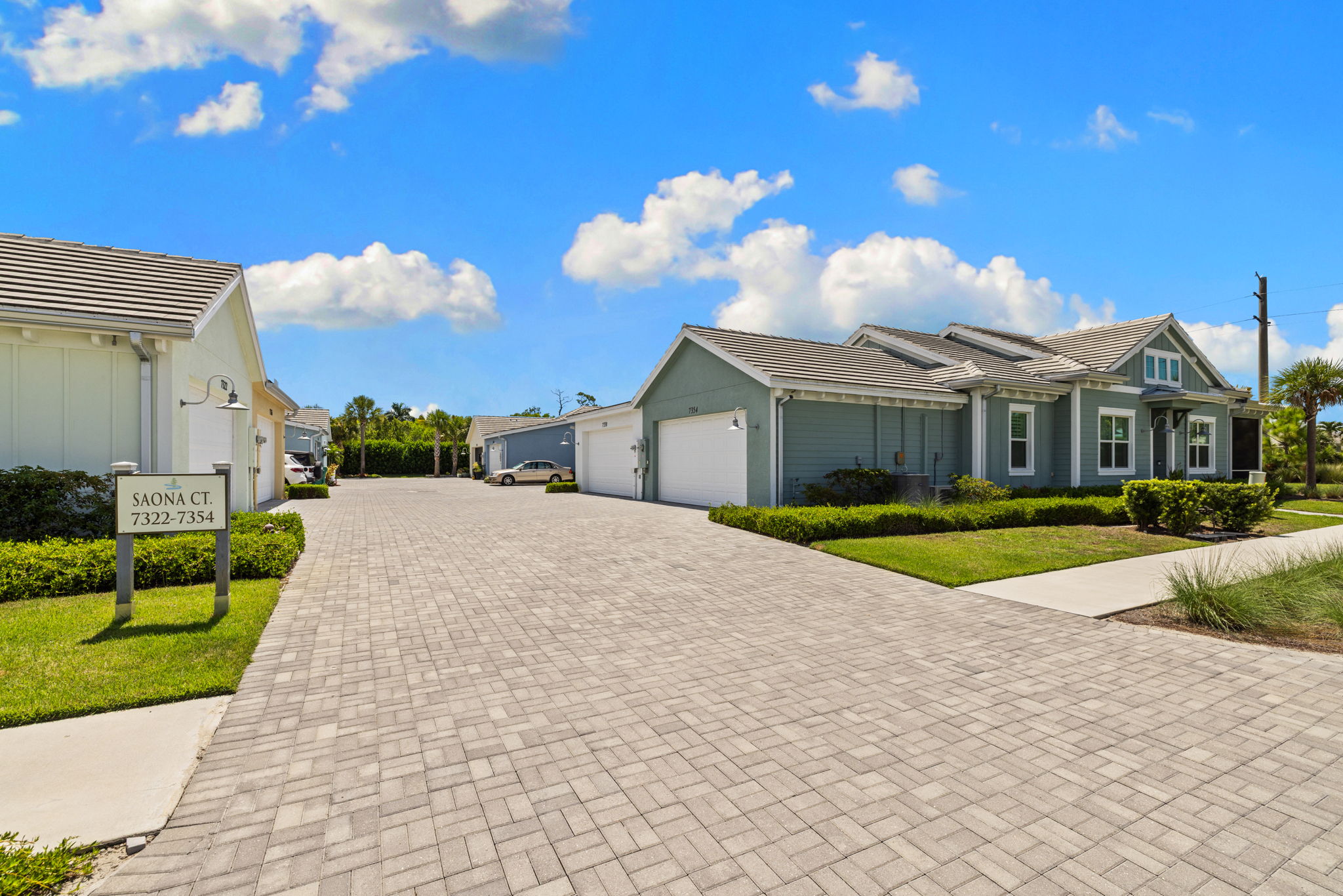Back of home garage parking paver driveway