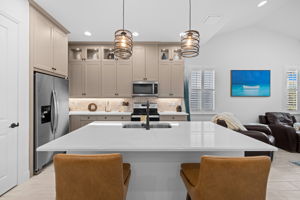 French doors & ice maker in fridge. Leather stools.