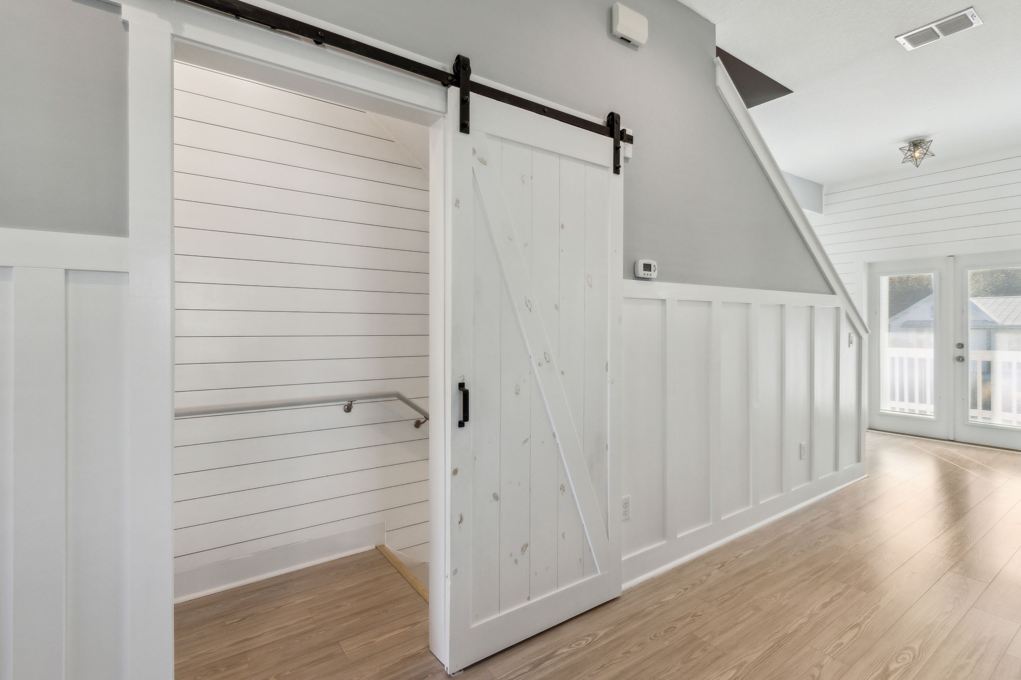 The custom crafted barn doors add a subtle nautical touch...