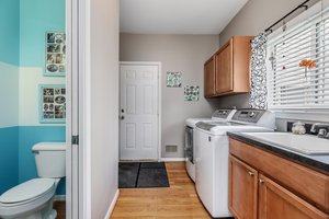 Laundry and mud room with bathroom for pool