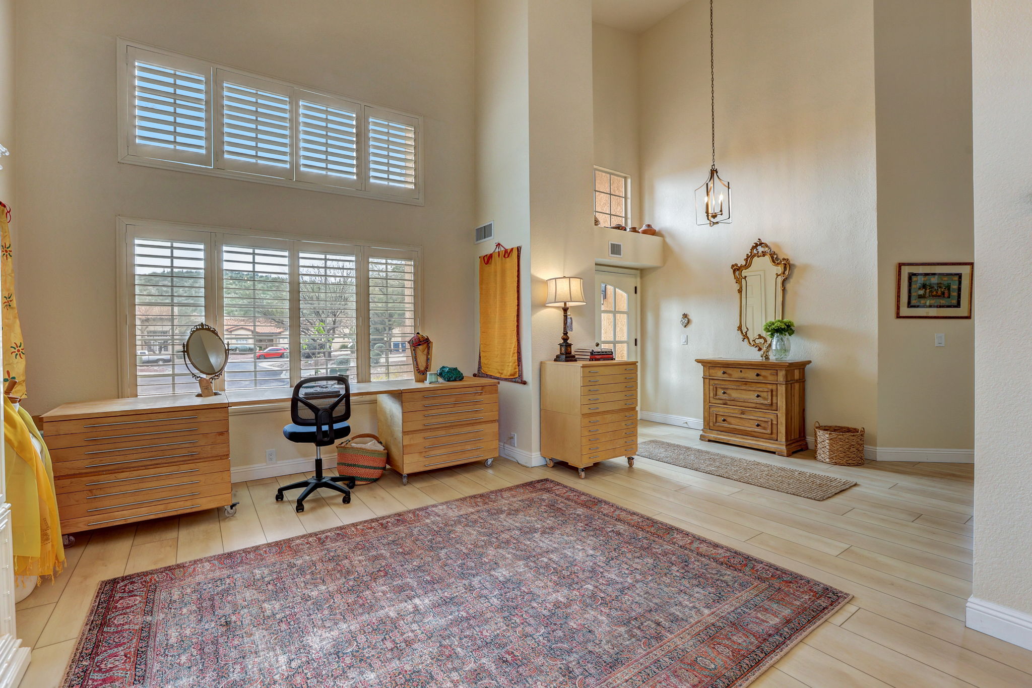 Great Room with 17-ft ceilings and Tall windows with Plantation Shutters