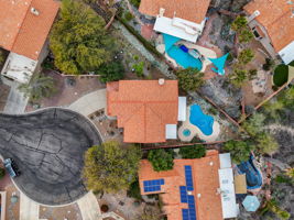 Drone view of cul-de-sac, pool, and extra-large side yard.