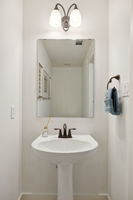 Guest bathroom off front entrance of home.