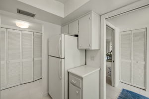 Kitchen view to foyer closet & hallway laundry