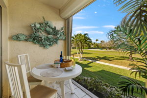 Screened Lanai off of primary bedroom features electric hurricane shutters & outdoor dining area
