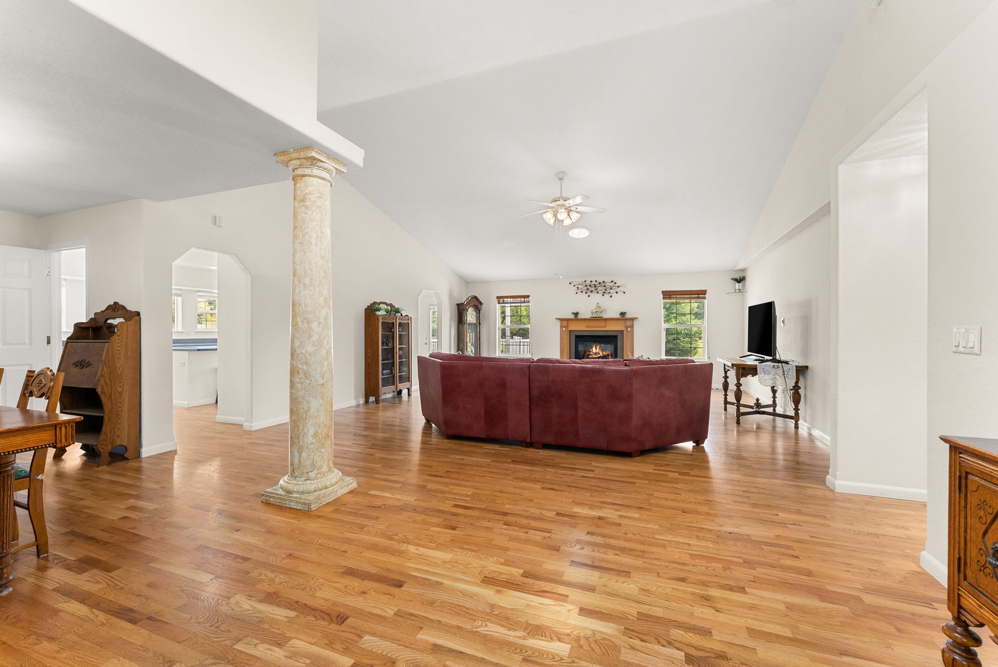 Expansive living room with hardwood flooring and seamless connection to dining