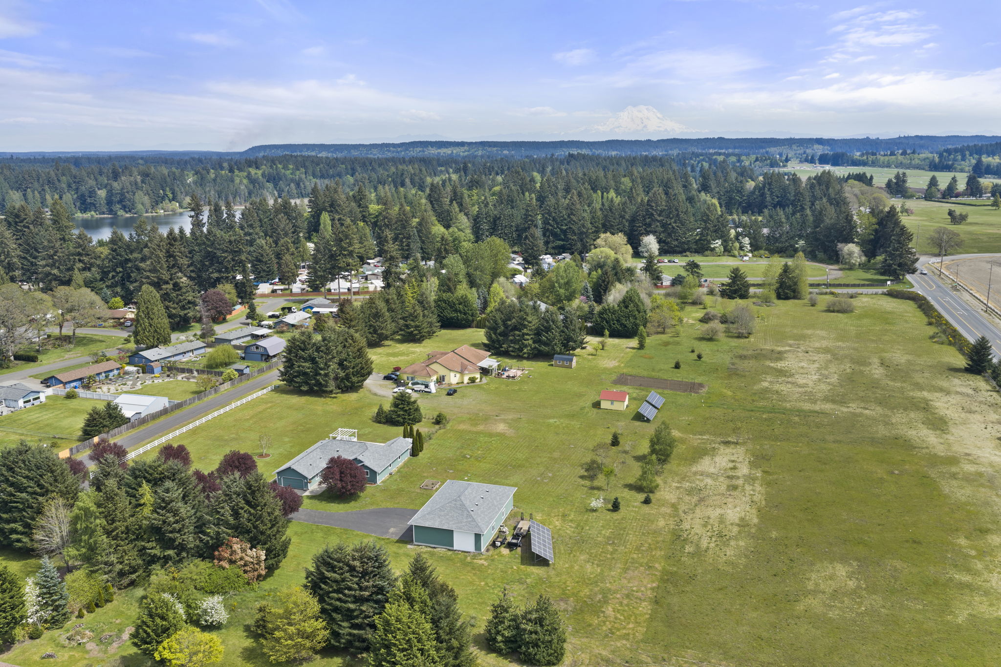 Aerial photos highlighting glimpses of nearby Pattison Lake and 7.84 kW grid-tied solar system (owned) enhances energy efficiency.