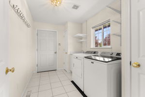 Spacious laundry room off the kitchen with window overlooking the front yard