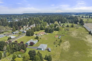 Aerial photos highlighting glimpses of nearby Pattison Lake and 7.84 kW grid-tied solar system (owned) enhances energy efficiency.