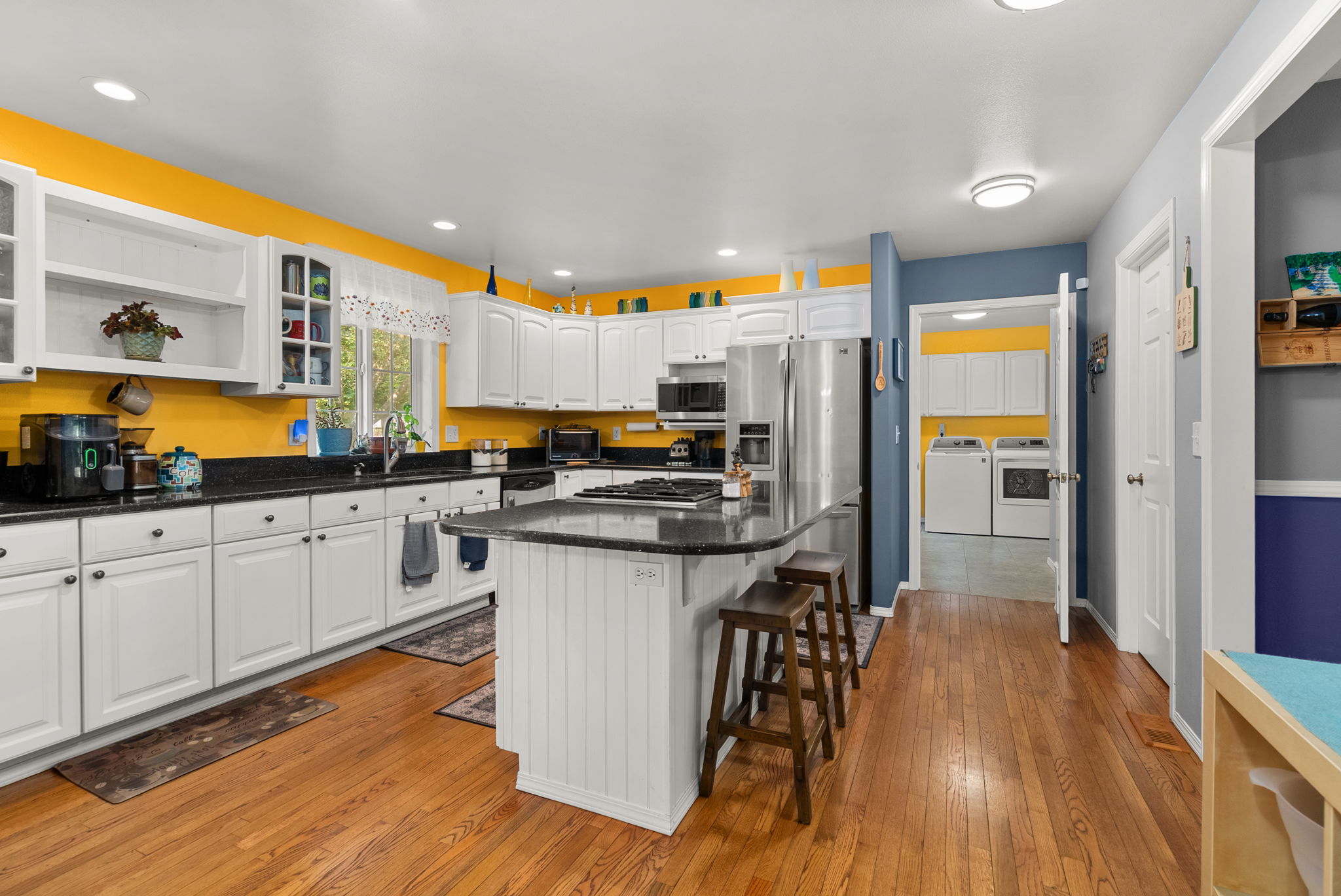 Abundant workspace, ample storage, and an oversized laundry room just steps away make daily life effortless.