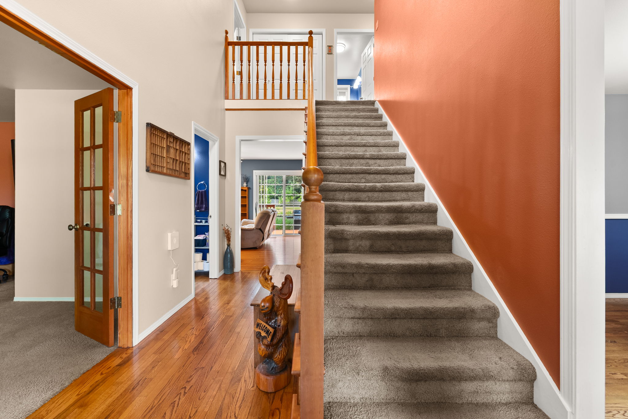 Vaulted ceilings, hardwood floors, and abundant natural light create an impressive entrance.