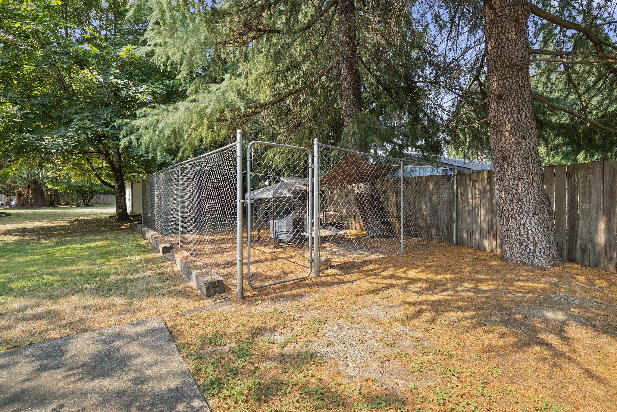 Dedicated fenced dog run provides a secure space for pets to play and exercise.