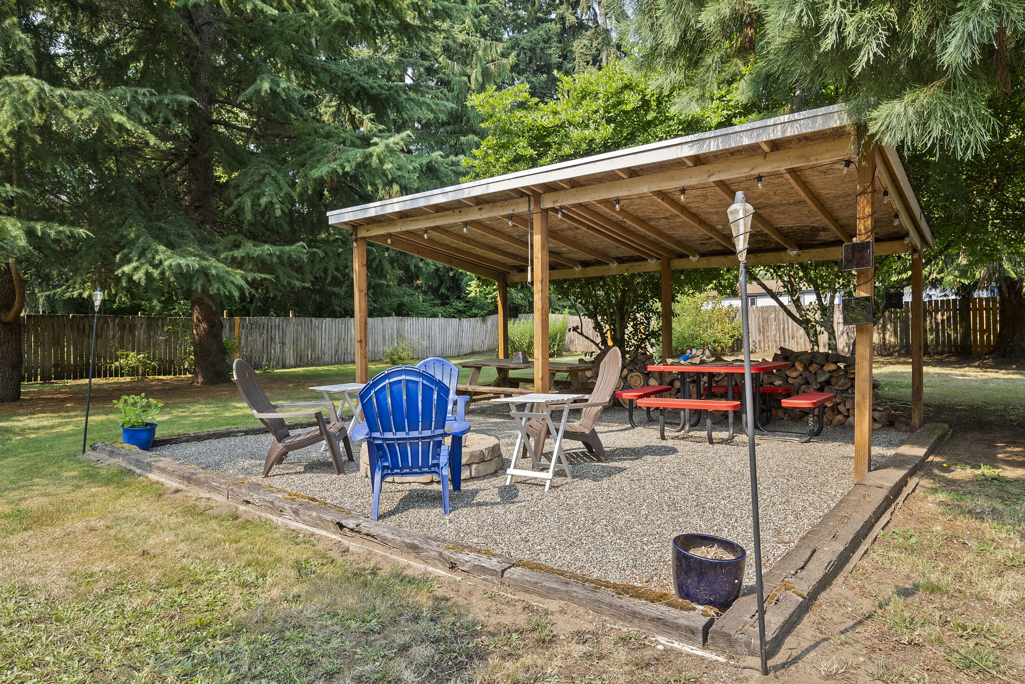 Gather year-round under the covered pavilion featuring a built-in fire pit, picnic area, and plenty of space for entertaining family and friends.