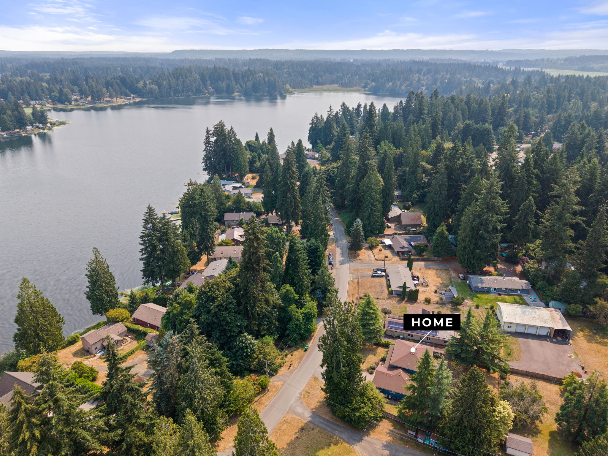 Warm lighting, towering evergreens, and timeless Northwest charm create a welcoming first impression.