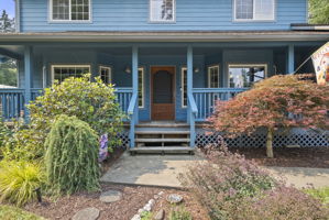A classic covered porch, colorful perennial gardens, and thoughtful landscaping welcome you home.