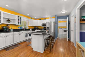 Abundant workspace, ample storage, and an oversized laundry room just steps away make daily life effortless.