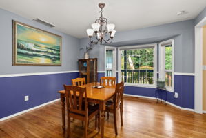 Formal dining room with elegant windows overlooking the front yard, creating the perfect setting for everyday meals or holiday gatherings.
