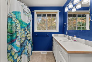 Bright upstairs full bath with oversized vanity and plenty of storage for busy mornings.