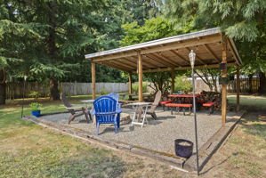 Gather year-round under the covered pavilion featuring a built-in fire pit, picnic area, and plenty of space for entertaining family and friends.