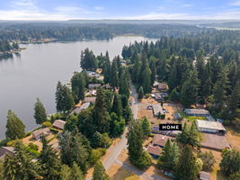 Warm lighting, towering evergreens, and timeless Northwest charm create a welcoming first impression.