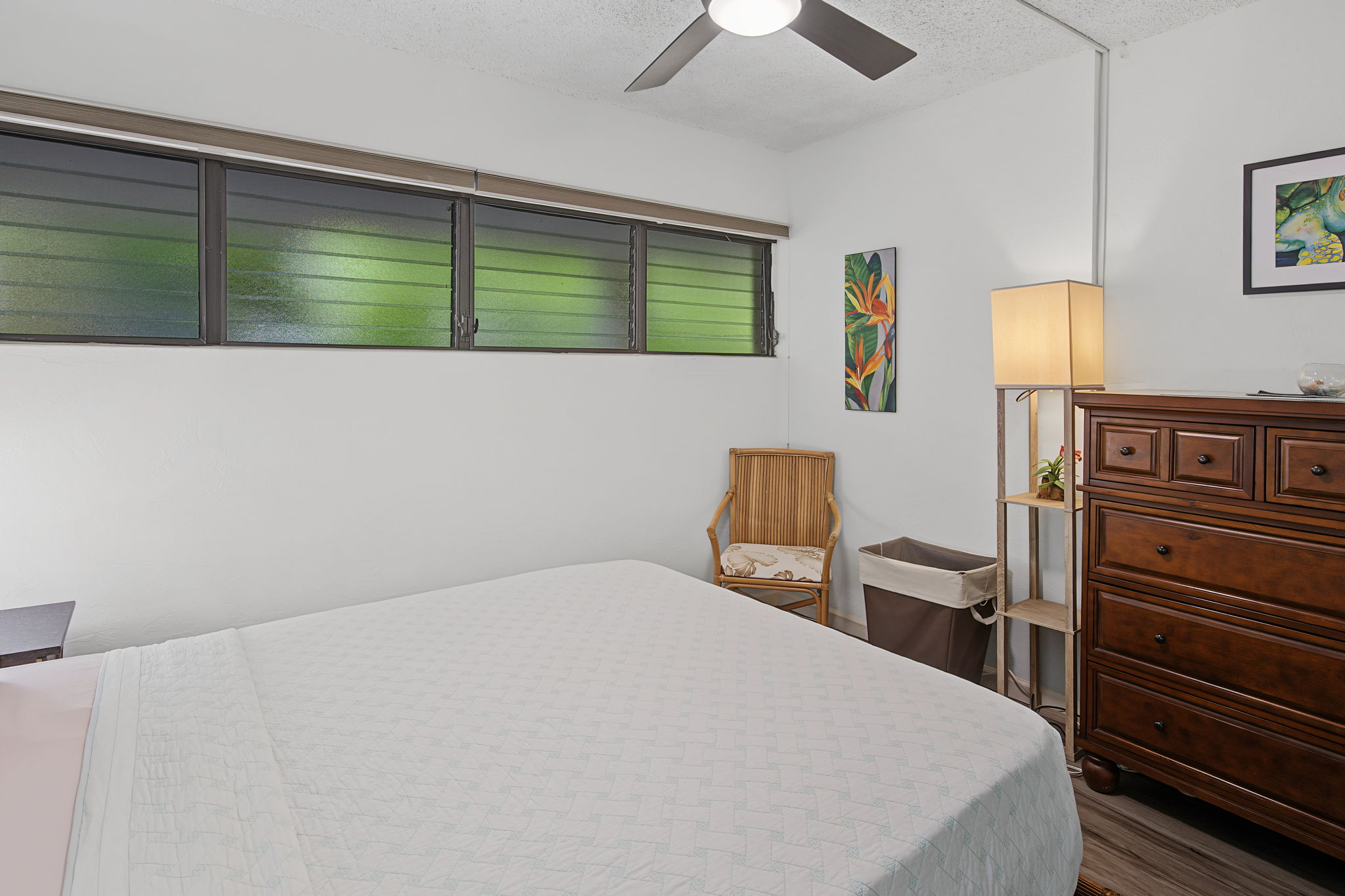 Bedroom with room for dresser and chairs. There's a desk in the living room.