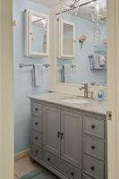 The bathroom is lovely and has a chandelier above the vanity.