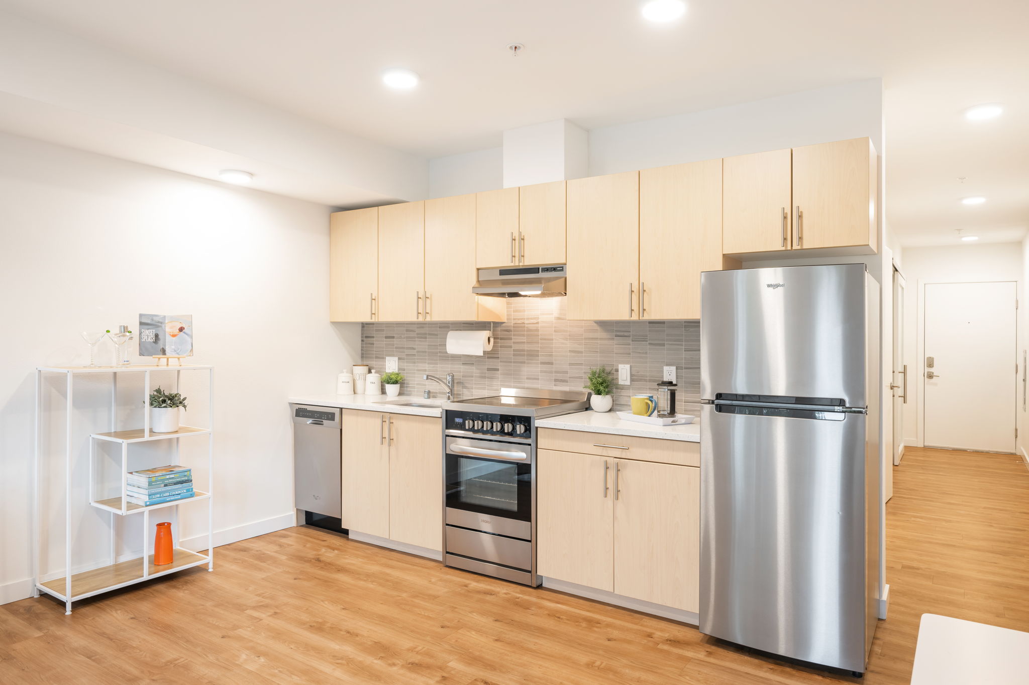 Well-appointed full-size kitchen with quartz countertops, sleek cabinetry, stainless appliances. Microwave is included (not shown in the photos)
