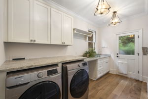 Laundry and half bath next to kitchen