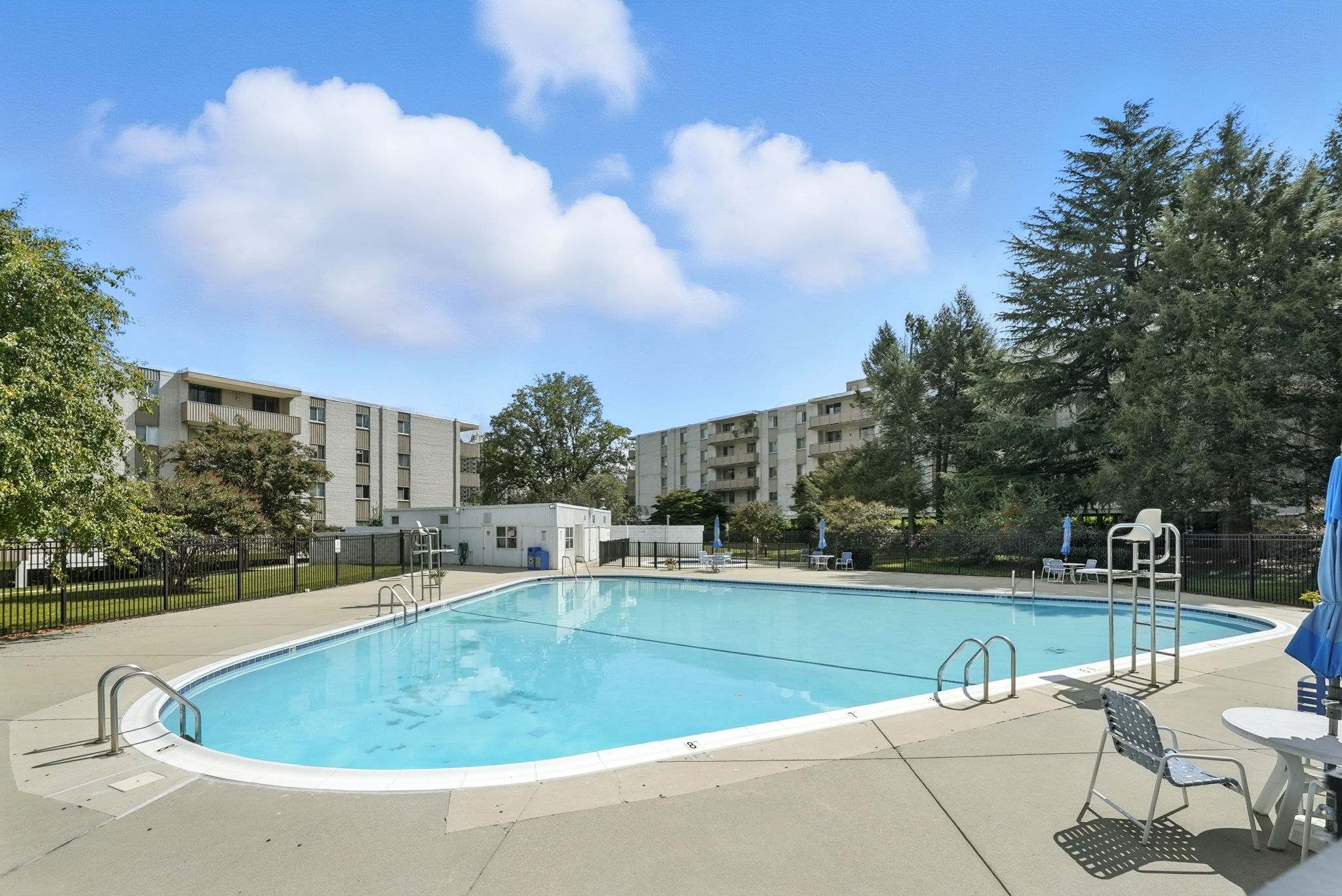 Fenced in community pool with lounge chairs!