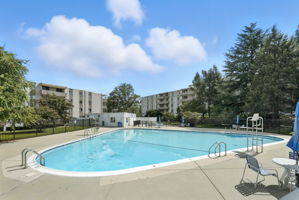 Fenced in community pool with lounge chairs!