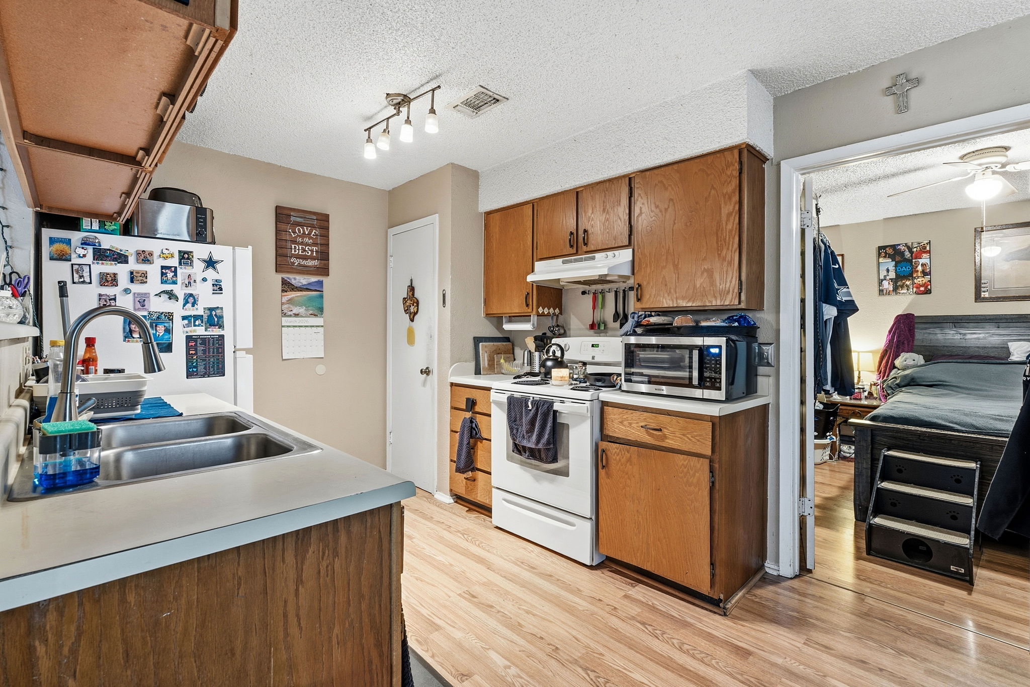 Unit A. Kitchen. With view to primary bedroom.