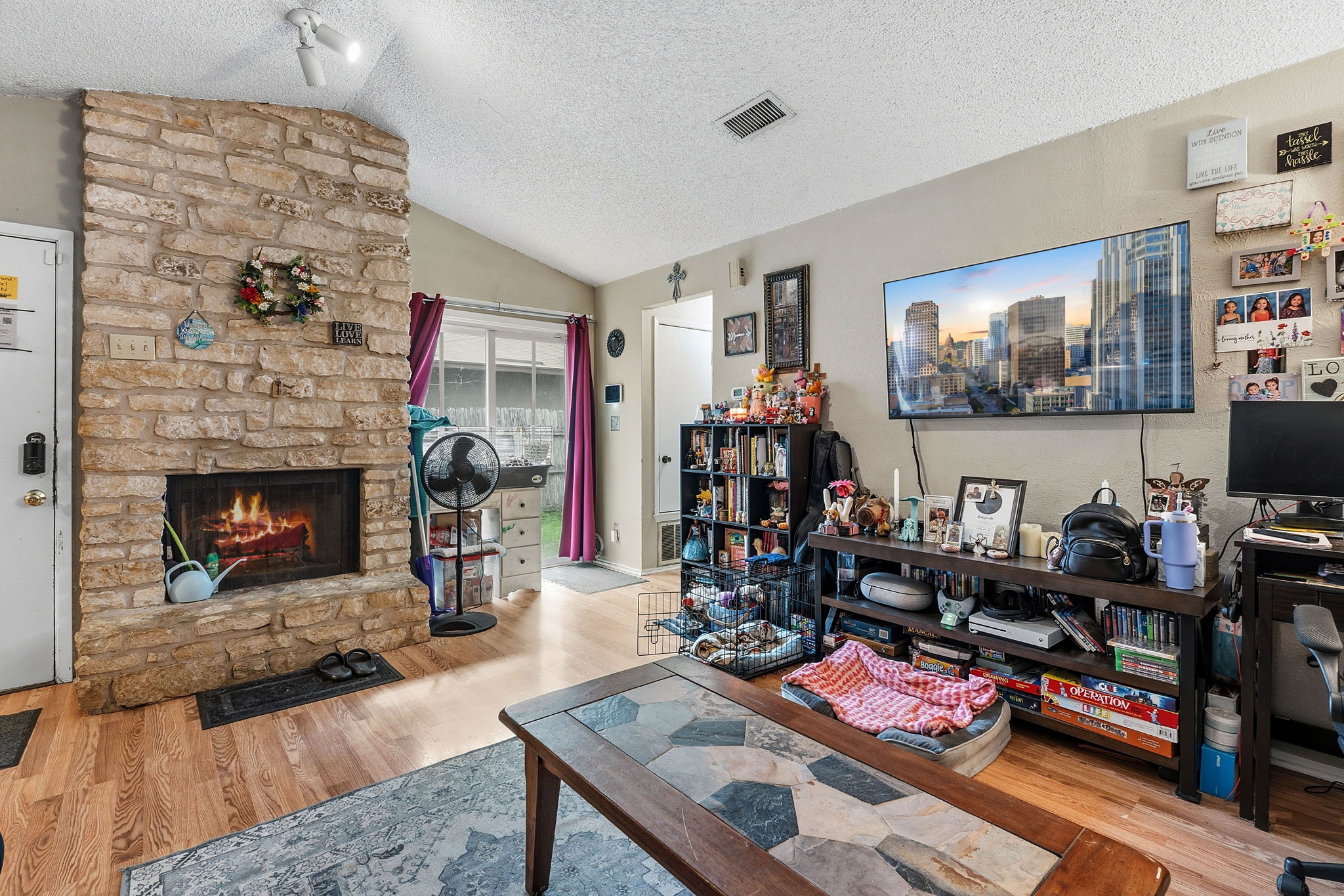 Unit A.  Each side has wood-burning stone veneer fireplace and updated windows and wood-look laminate floors.