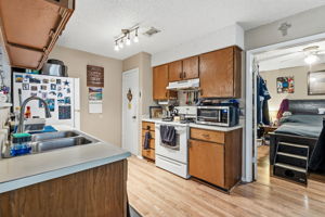 Unit A. Kitchen. With view to primary bedroom.