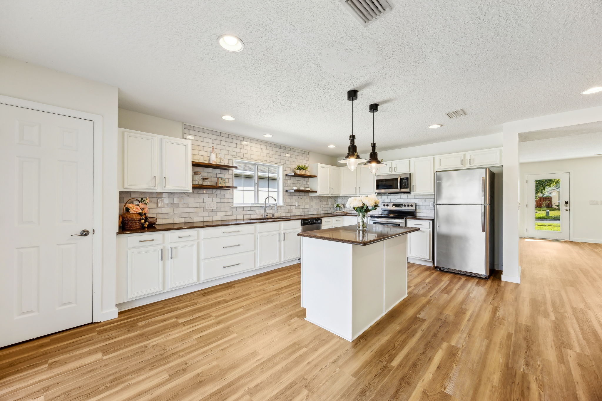 The updated kitchen features granite countertops ...