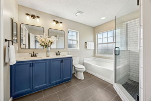 The updated master bath features a comfort-height vanity ...