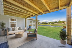 Outside, the covered patio provides tranquil views of the lake and fountain