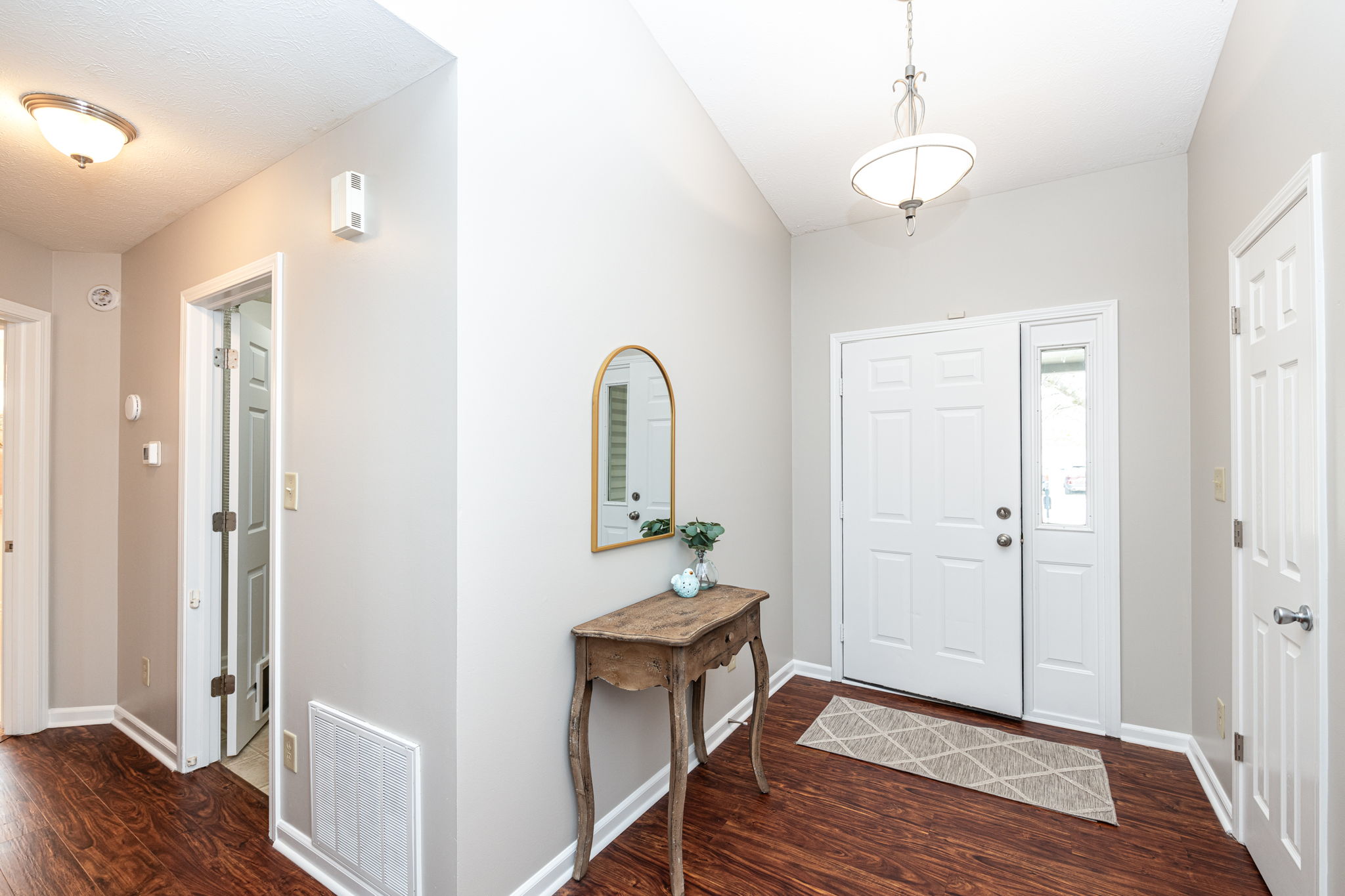 Lovely foyer with chandelier and coat closet welcome you home.