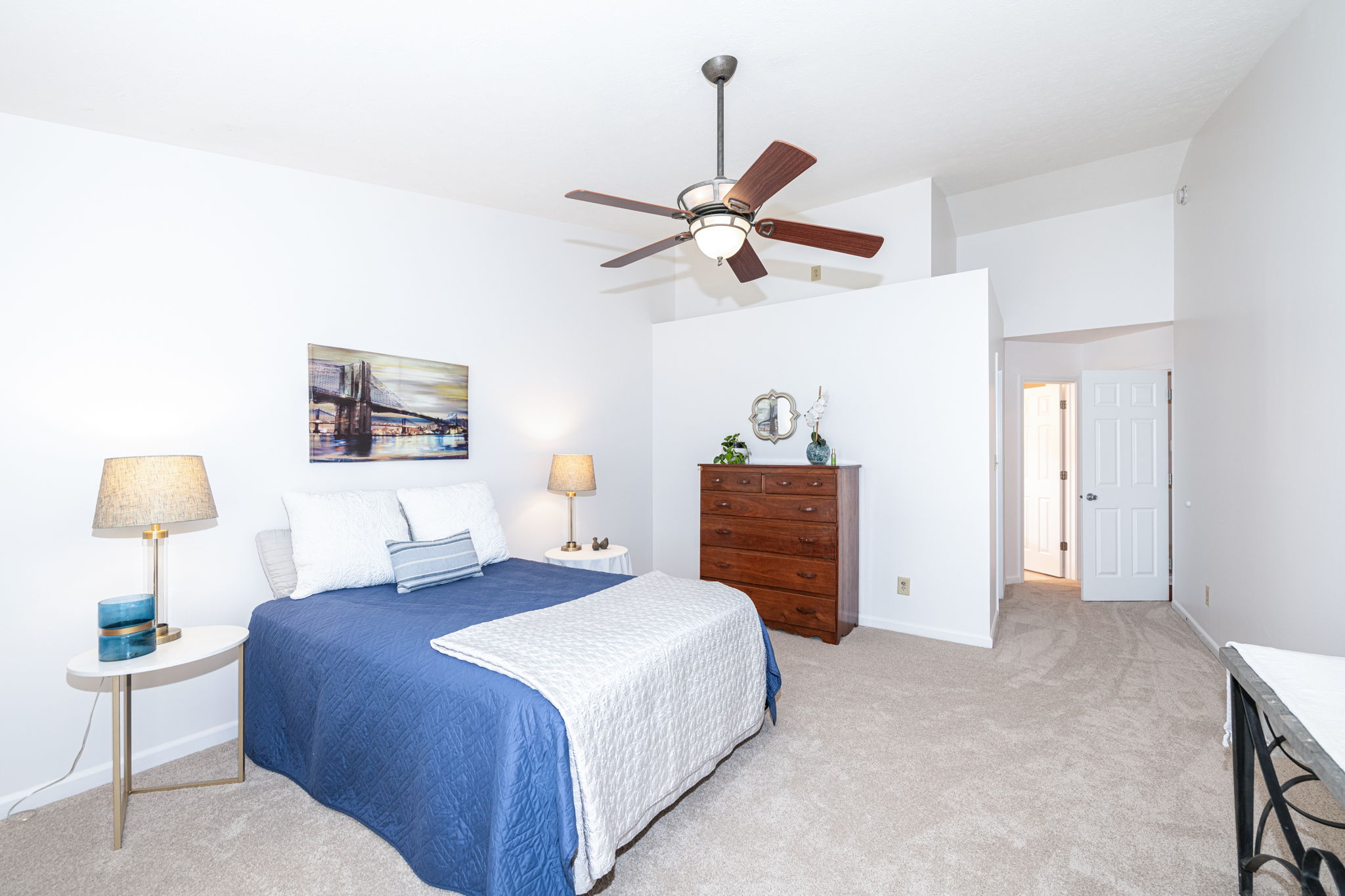 Vaulted ceiling enhances the spaciousness of this lovely primary bedroom with the perfect evening sunset views.