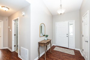 Lovely foyer with chandelier and coat closet welcome you home.