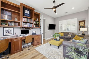Office with Built In Shelving and Desks